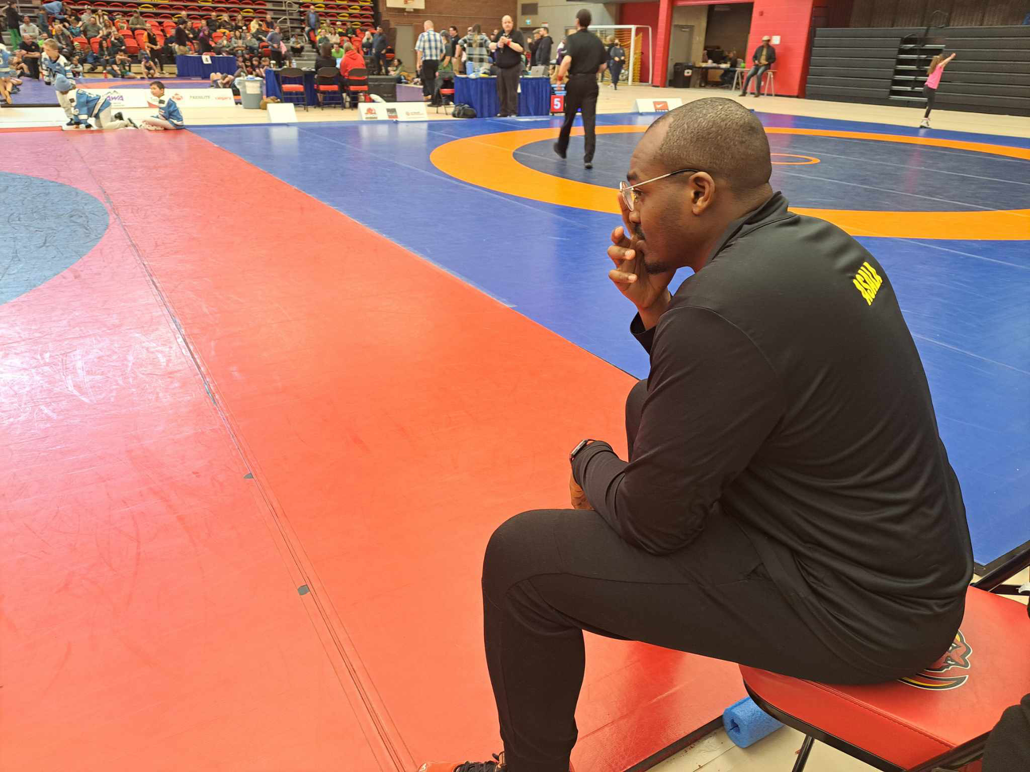 Baldwin Asala coaching matside at a wrestling tournament in Calgary