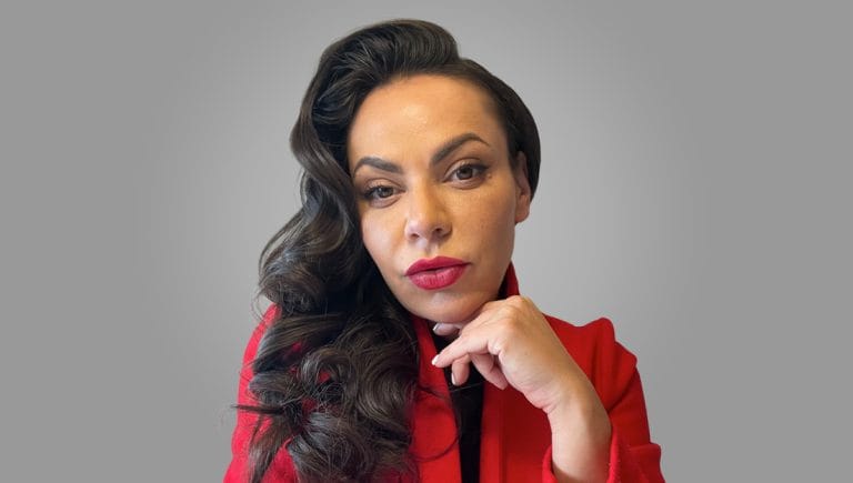 Portrait of Andrea McTague, Founder of the ShiftGrit Core Method™ and Registered Psychologist in Edmonton, Alberta, smiling in a professional setting.