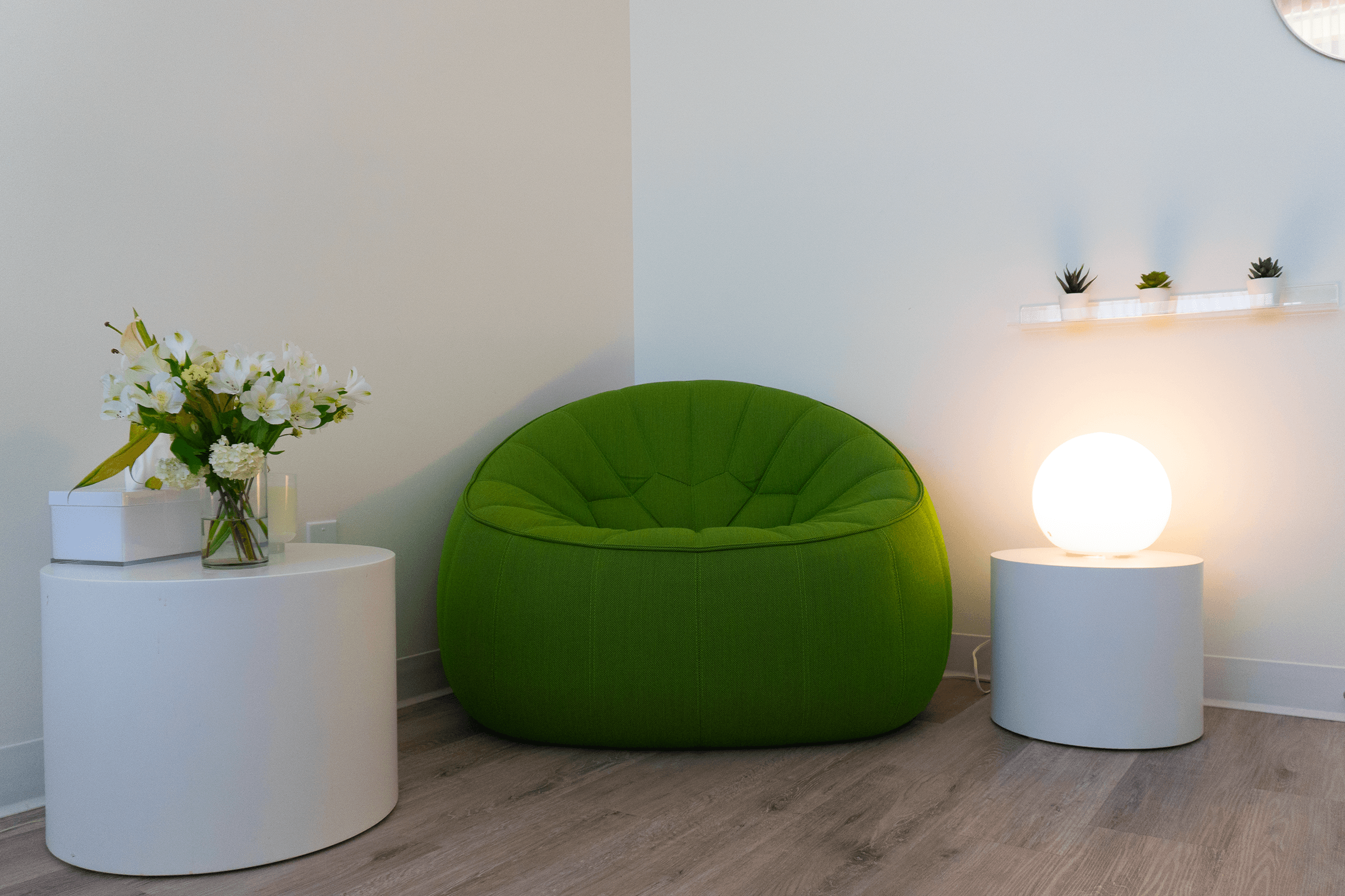 Interior of ShiftGrit Psychology & Counselling’s Edmonton therapy office – green chair and modern decor in a calming space