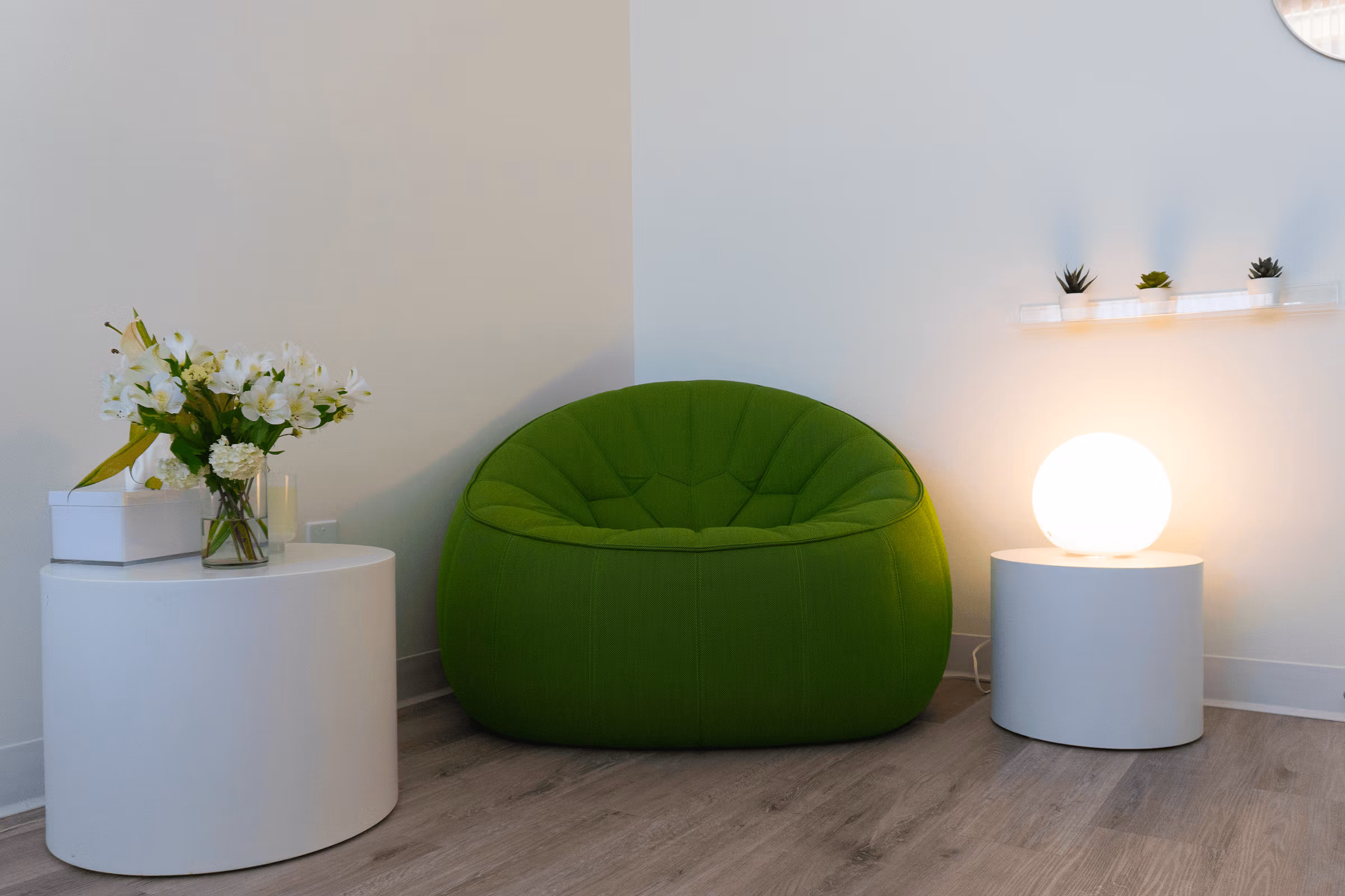 Interior of ShiftGrit Psychology & Counselling’s Edmonton therapy office – green chair and modern decor in a calming space